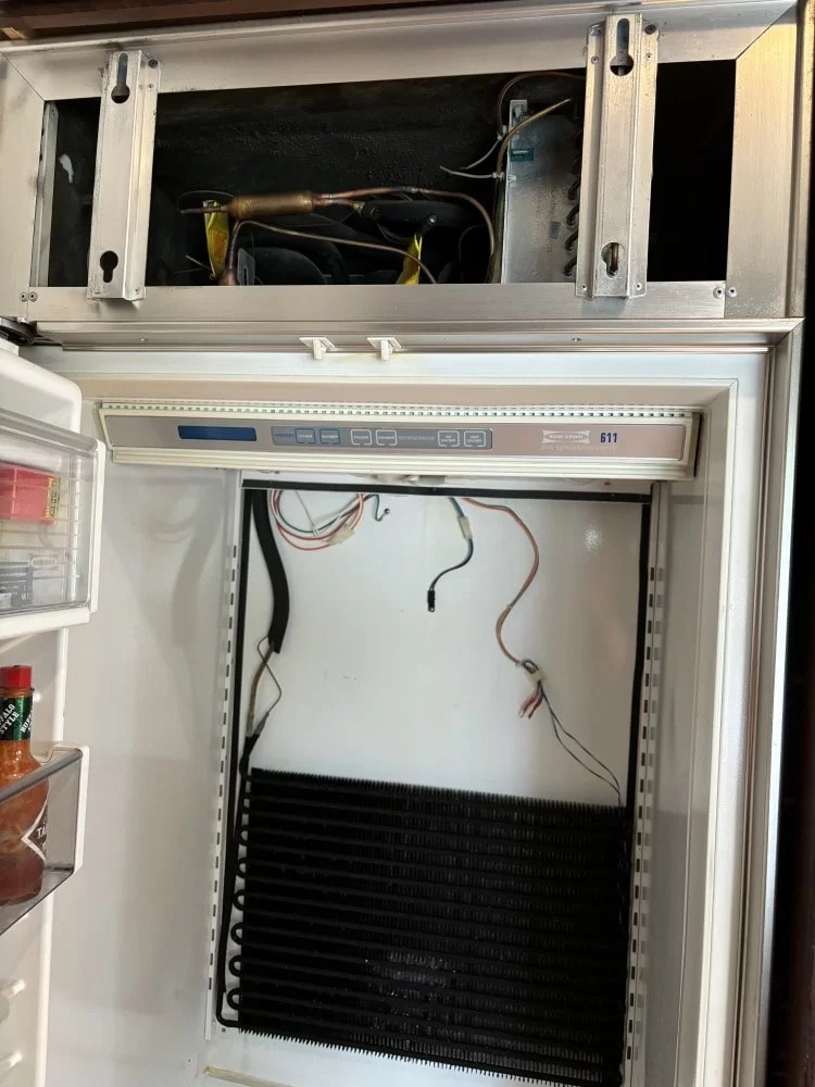Built-in refrigerator opened for internal repair