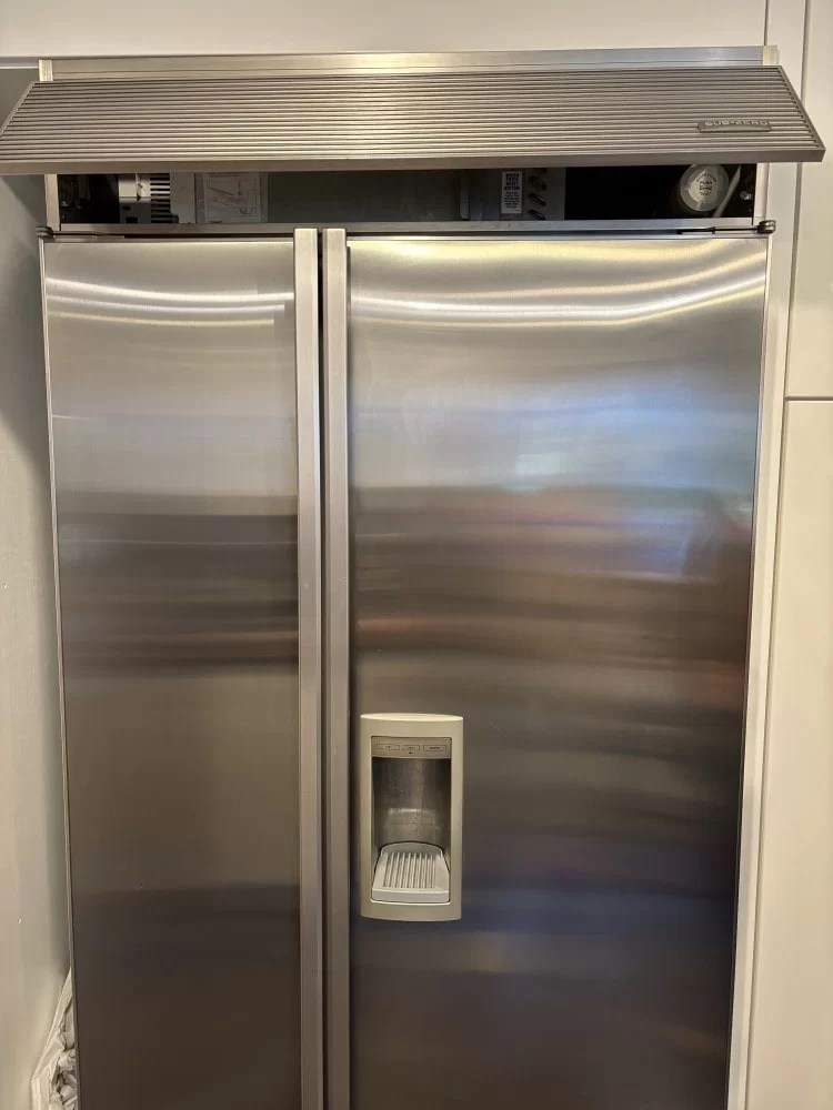 Stainless built-in refrigerator during a service visit