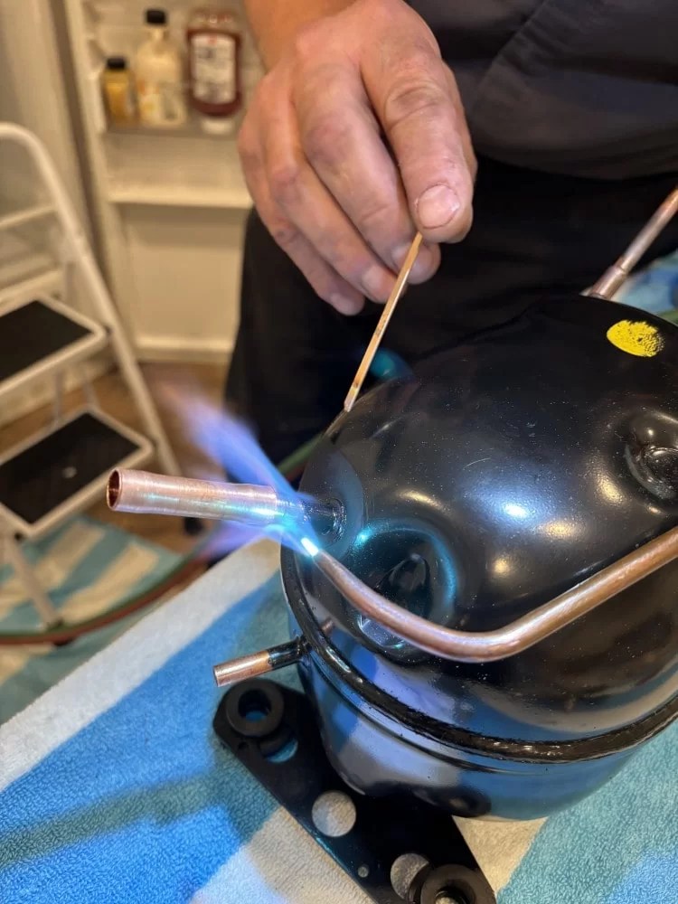 Compressor repair with brazing torch