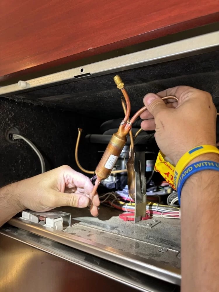 Refrigeration tubing repair in progress