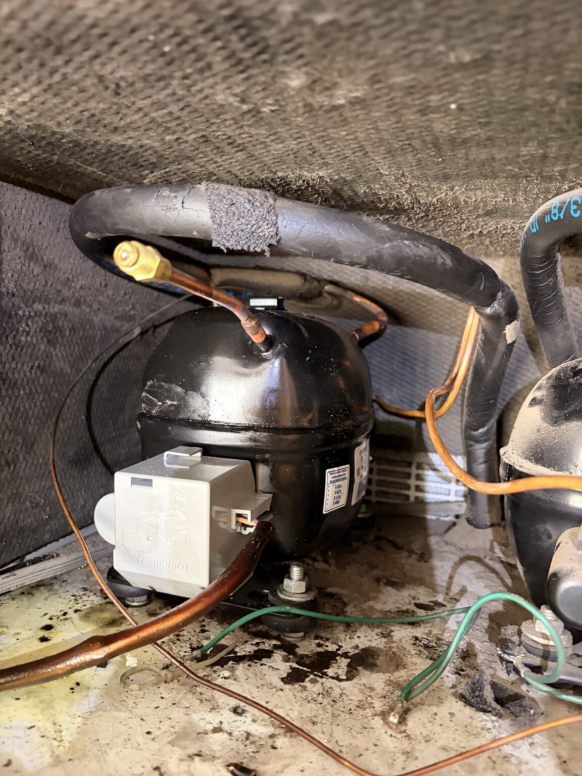 Refrigerator compressor and tubing after service
