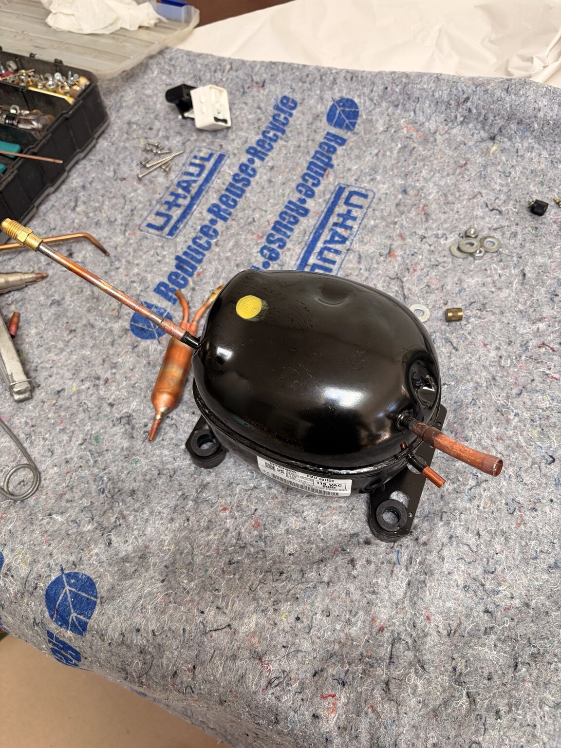 Replacement refrigeration compressor prepared for installation